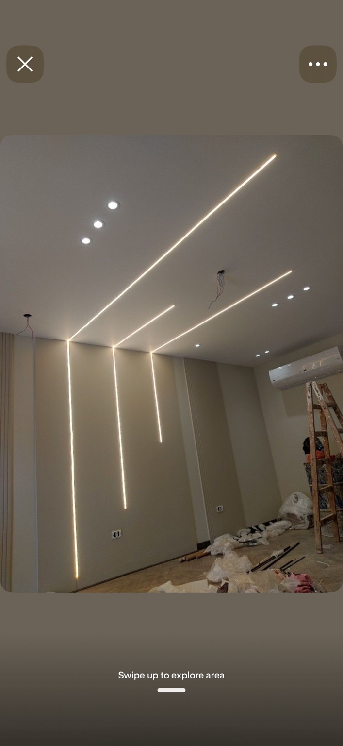 Linear LED lighting extending from ceiling down the wall