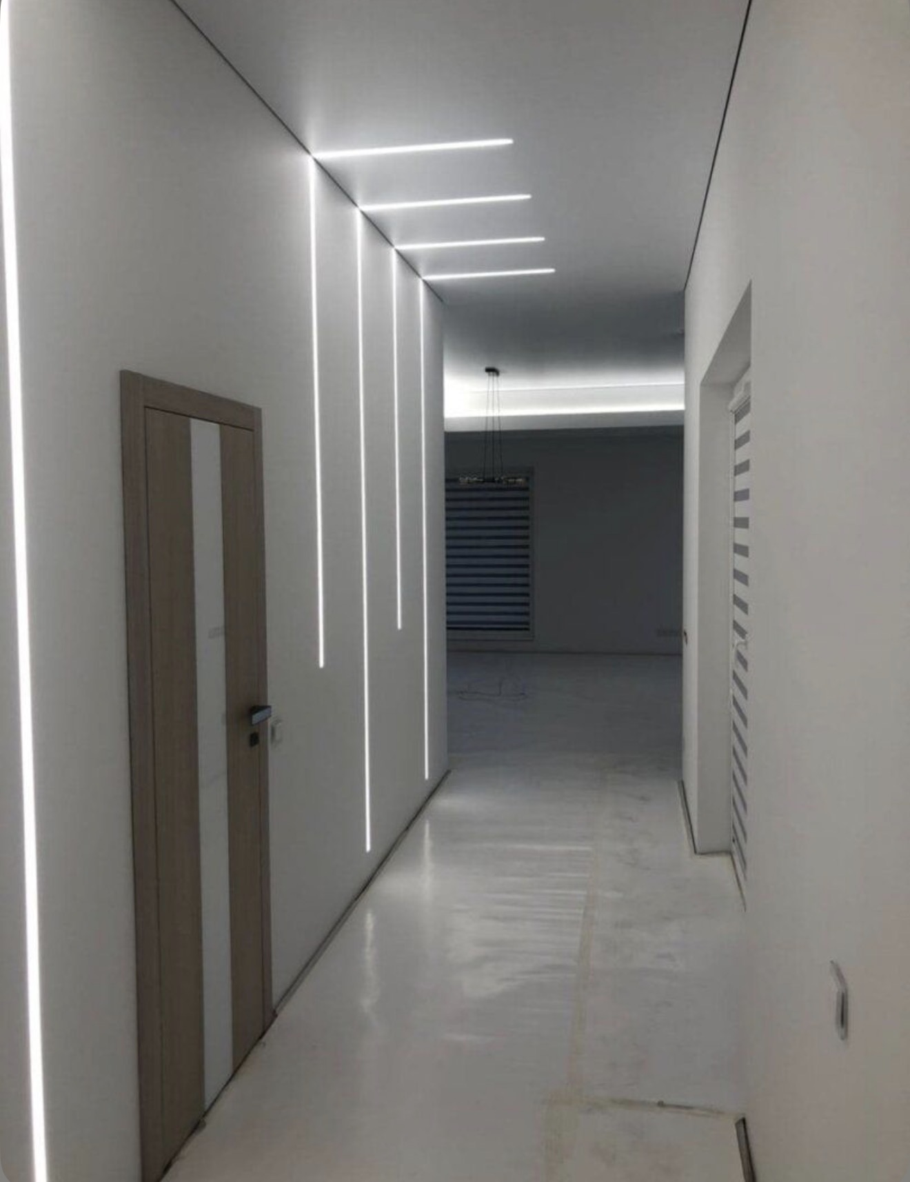 Modern hallway with vertical wall and ceiling LED lines